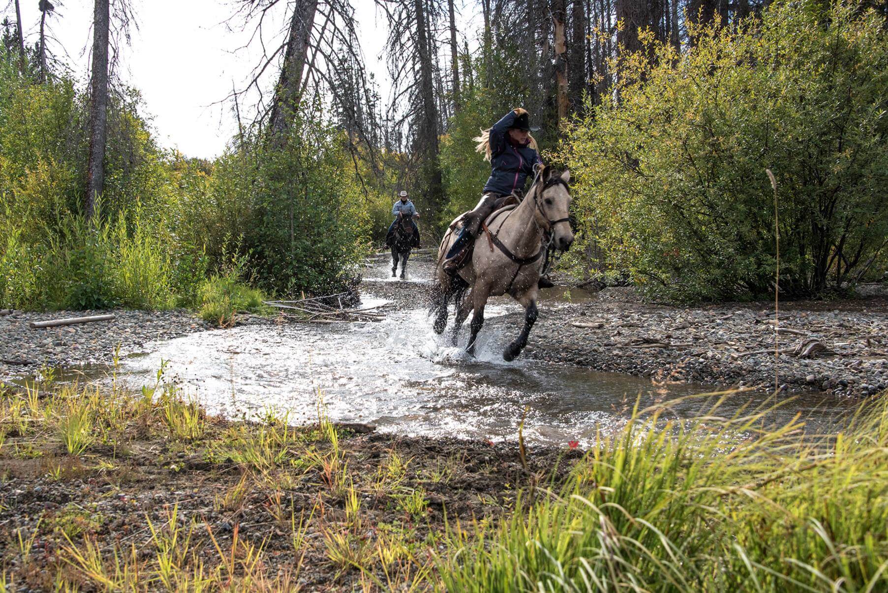 woman-riding-horse-through-water